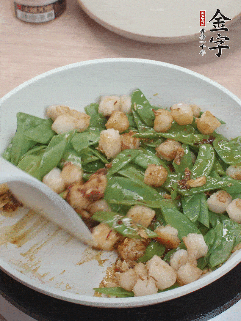 下甜豆莢、鮮貝輕輕翻炒均勻。