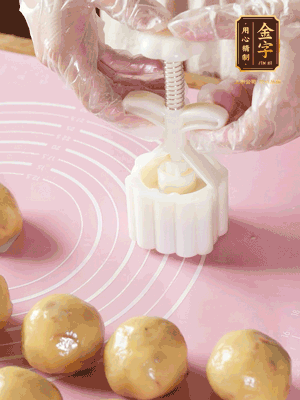 收緊虎口搓圓，裹上一層面粉，放入模具壓一壓